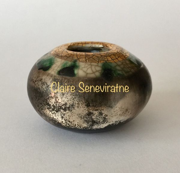 Small smoke fired pot with gold.