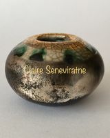 Small smoke fired pot with gold.