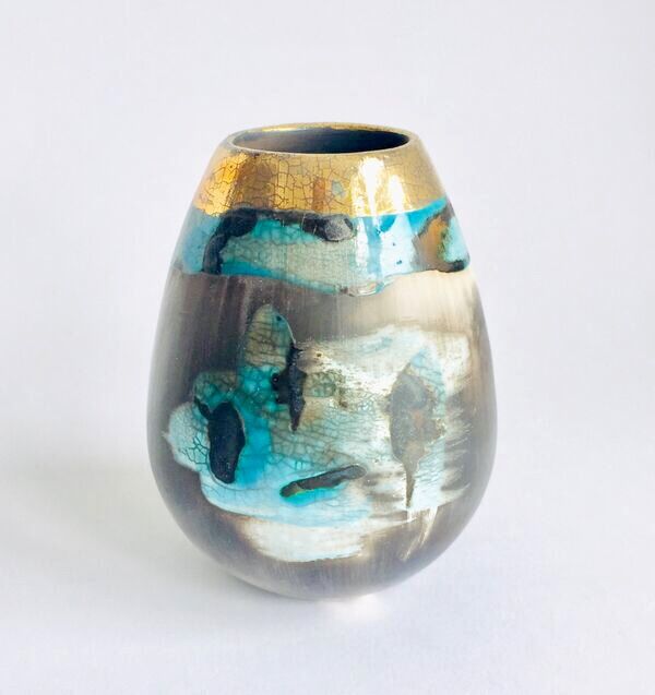 Blue smoke-fired ceramic pot with glaze and gold lustre.