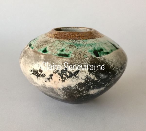 Round smoke fired pot with gold.