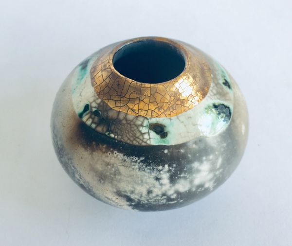 Round smoke fired pot with gold.