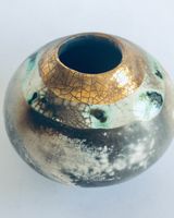 Round smoke fired pot with gold.