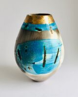 Blue smoke-fired ceramic pot with glaze and gold lustre.