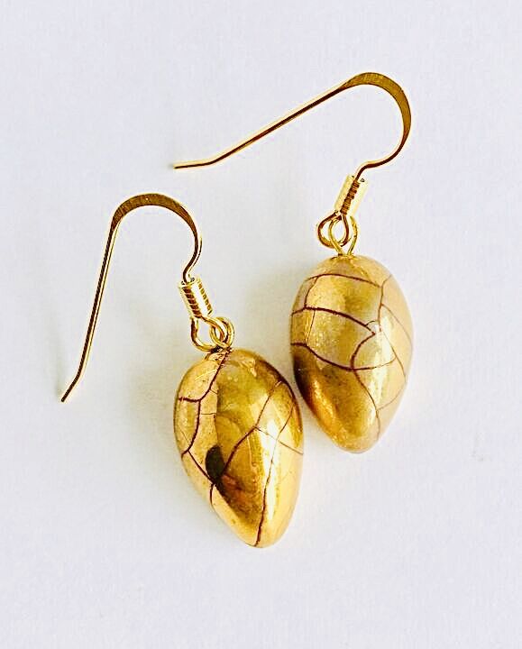 Gold teardrop earrings.