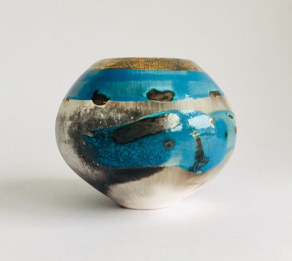 Blue smoke-fired ceramic pot with gold lustre.
