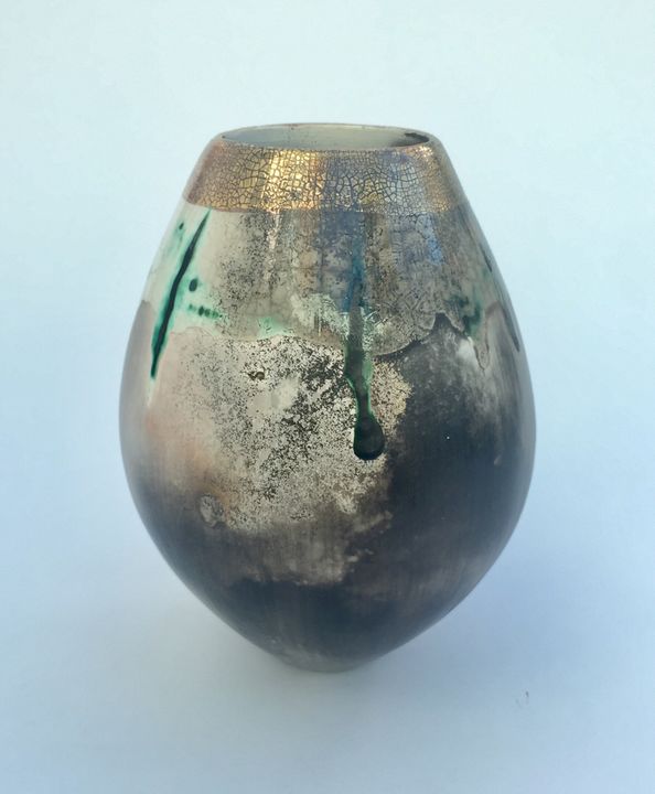 Sawdust fired ceramic pot partial glaze and gold lustre.