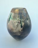 Sawdust fired ceramic pot partial glaze and gold lustre.