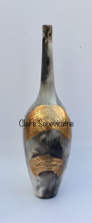 Smoke fired pot with long neck.