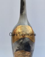 Smoke fired pot with long neck.