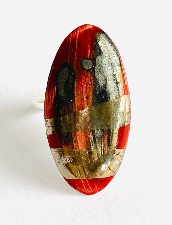 Large red ring with silver lustre.