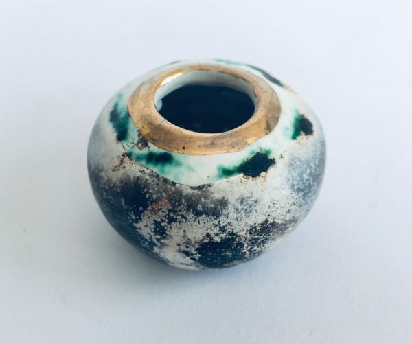 Small smoked fired vessel with gold.