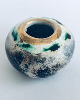 Small smoked fired vessel with gold.