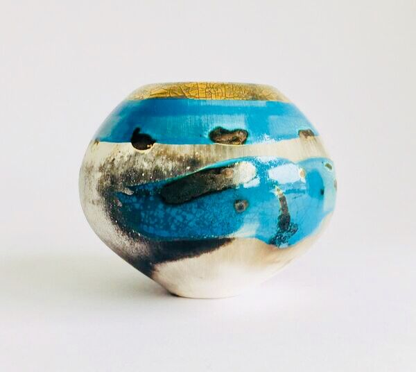 Blue smoke-fired ceramic pot with gold lustre.