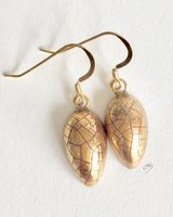 Gold teardrop earrings.