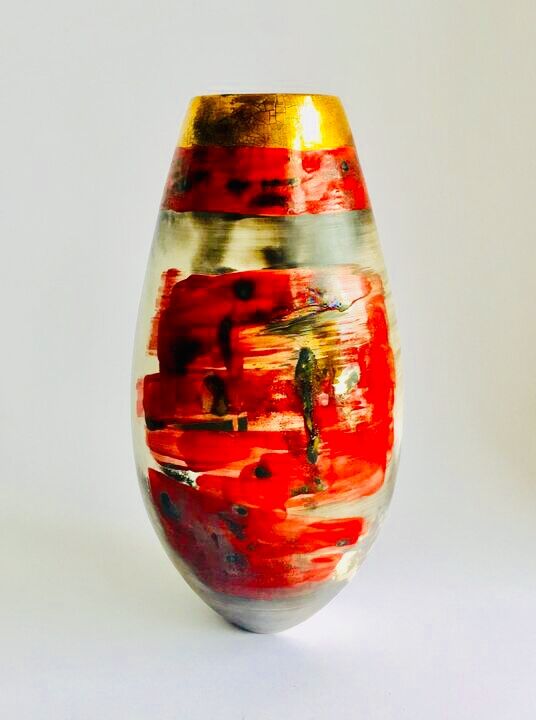 Red smoke-fired pot with gold lustre.