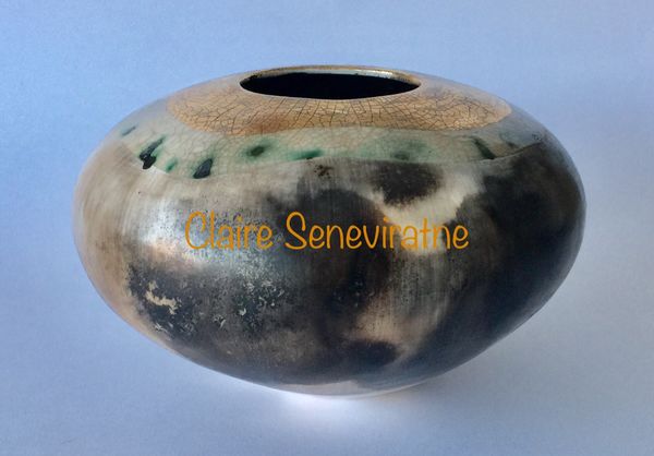 Round smoke fired ceramic pot.