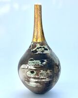 Ceramic pot, smoke-fired, with a long gold lustre neck.