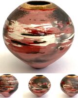 Red smoke fired pot with gold lustre.