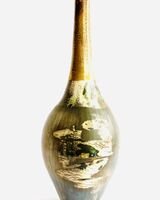 Burnished smoke-fired ceramic pot with gold lustre.