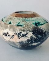 Round smoke fired pot with gold.