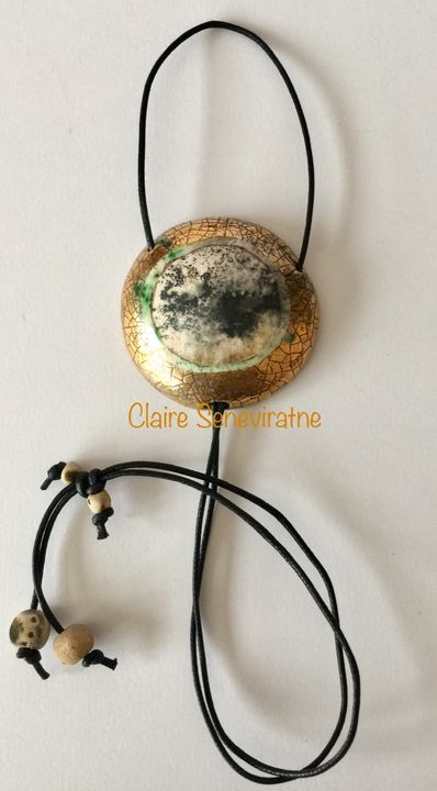 Round smoke fired pendant with gold.