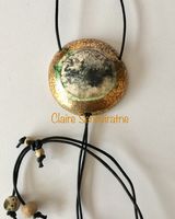 Round smoke fired pendant with gold.
