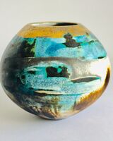 Blue smoke-fired ceramic pot with glaze and gold lustre.