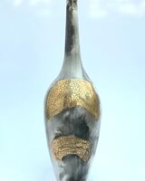 Smoke fired pot with long neck.