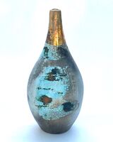 Small blue smoke-fired ceramic pot with gold lustre.
