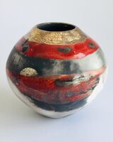 Red smoke-fired pot with gold lustre.