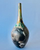 Smoke fired pot with long neck and gold lustre.