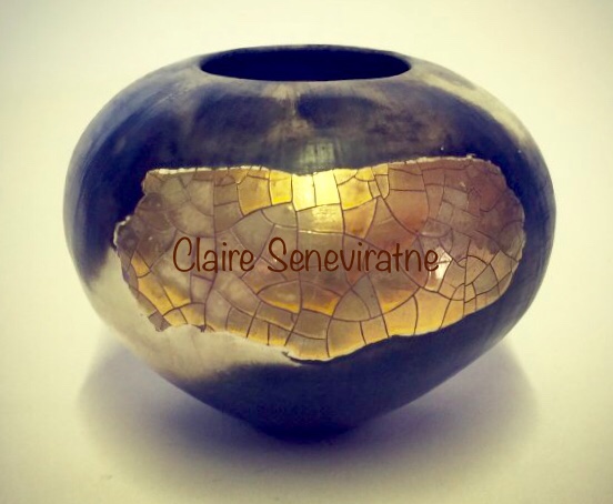 Porcelain smoke-fired pot with gold lustre.