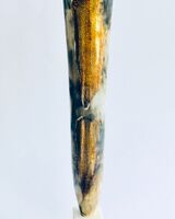 Tall smoke-fired pot with gold lustre.
