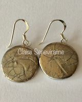 Round ceramic earrings with silver lustre.