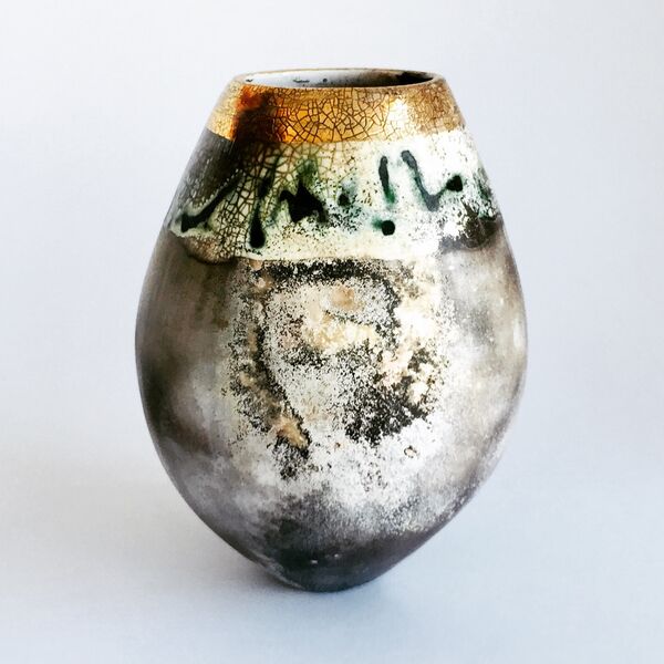 Smoke-fired pot with gold lustre and copper carbonate markings.