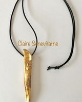 Gold sculptural long pendant.