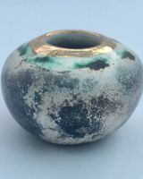 Small smoked fired vessel with gold.
