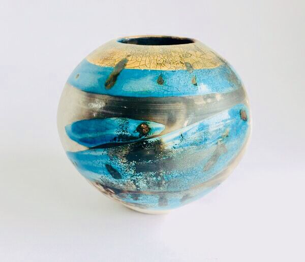Blue smoke-fired ceramic pot with glaze and gold lustre.