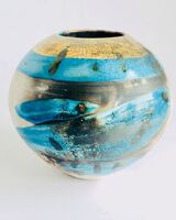 Blue smoke-fired ceramic pot with glaze and gold lustre.