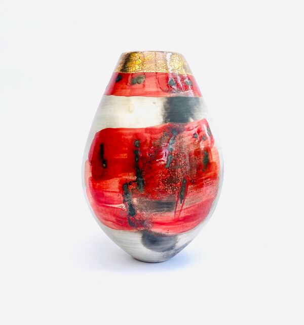 Red smoke-fired pot with gold lustre.