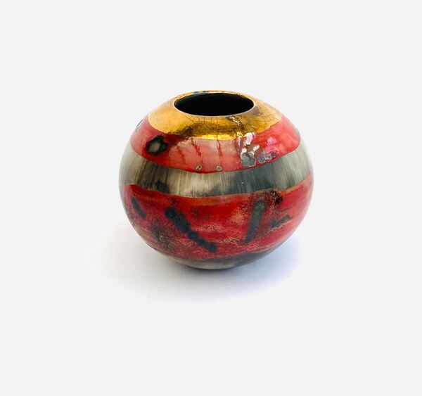 Small red smoke-fired porcelain vessel.