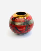 Small red smoke-fired porcelain vessel.