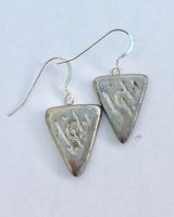 Silver triangle earrings.