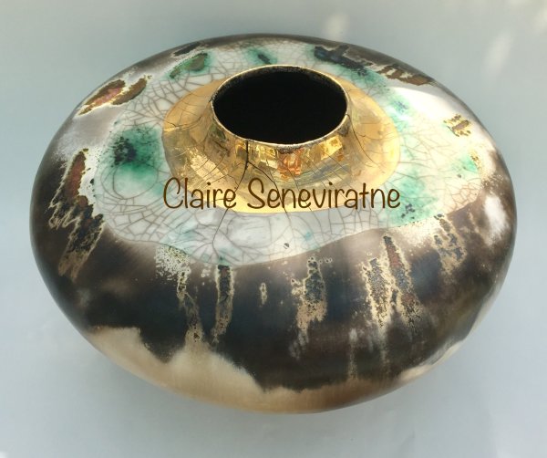 Large round smoke fired pot with gold lustre.