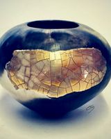 Porcelain smoke-fired pot with gold lustre.