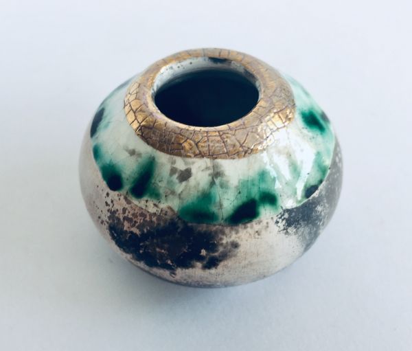 Small smoke fired pot with gold.
