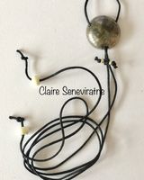 Round silver pendant with crackled textures.