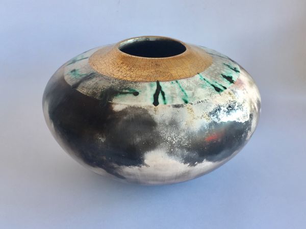 Large smoke-fired ceramic pot with gold lustre.