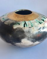 Large smoke-fired ceramic pot with gold lustre.