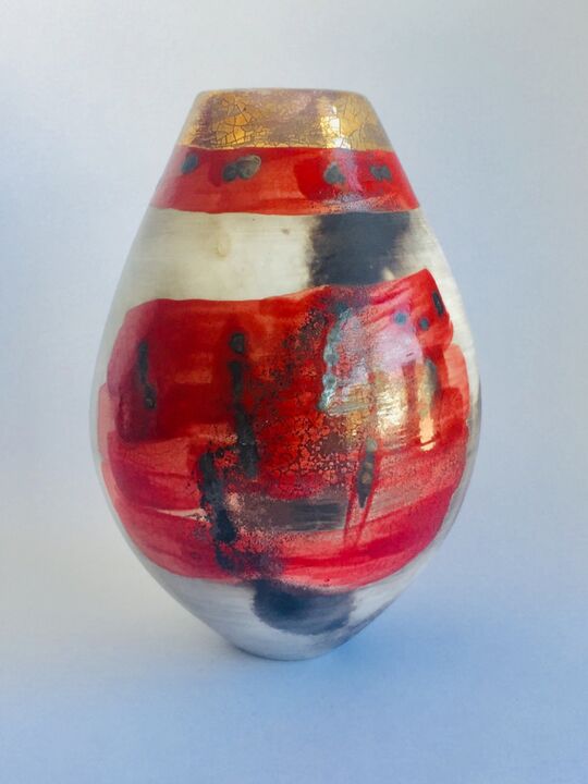 Red smoke-fired pot with gold lustre.